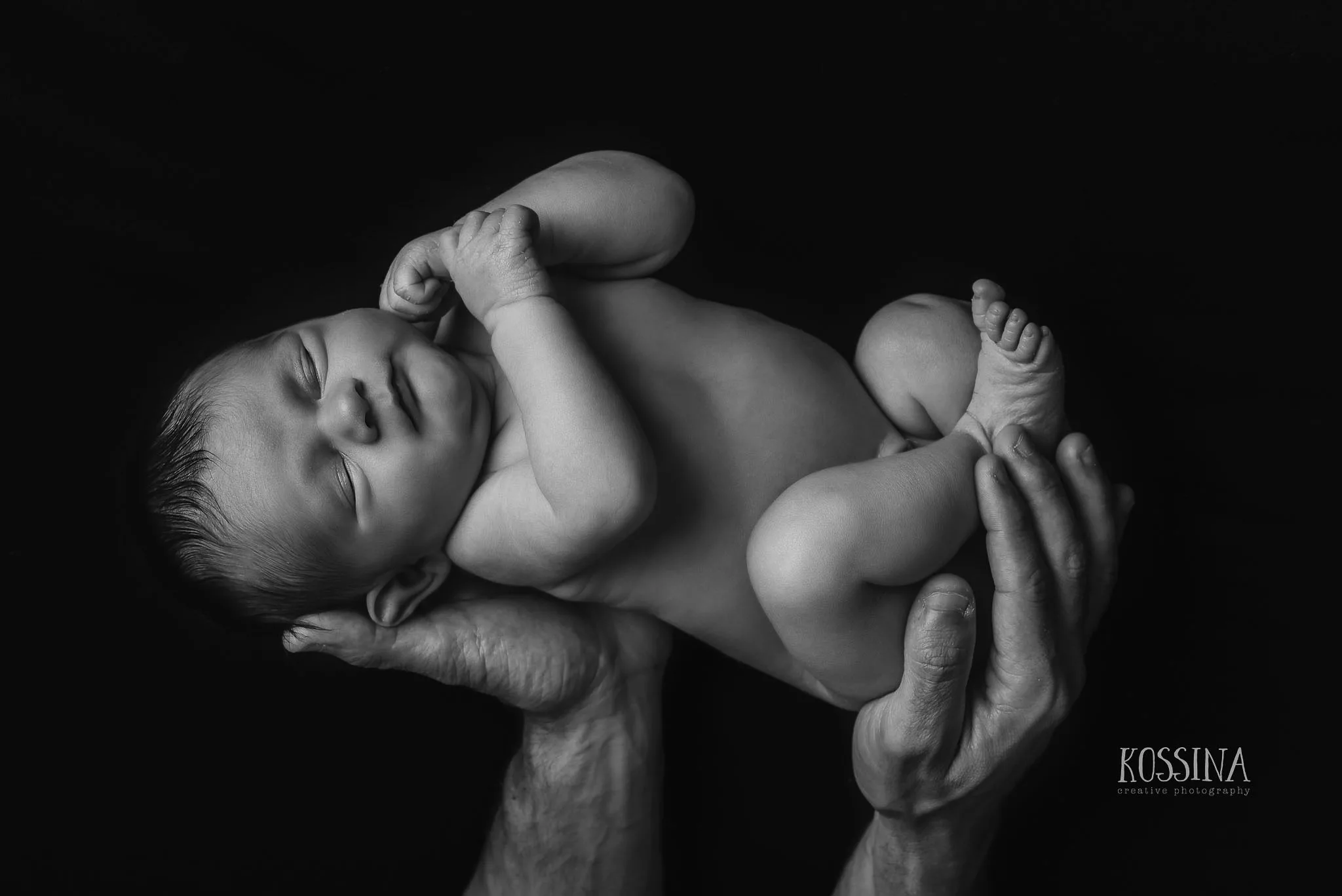 newborn girl fathers hands