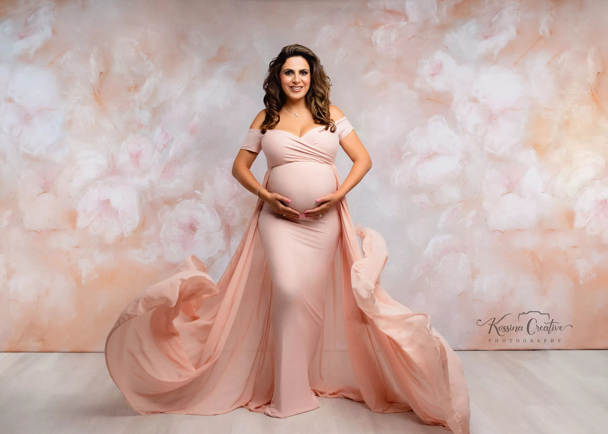 Orlando Maternity Photographer Photo Studio pink flowy dress with floral background