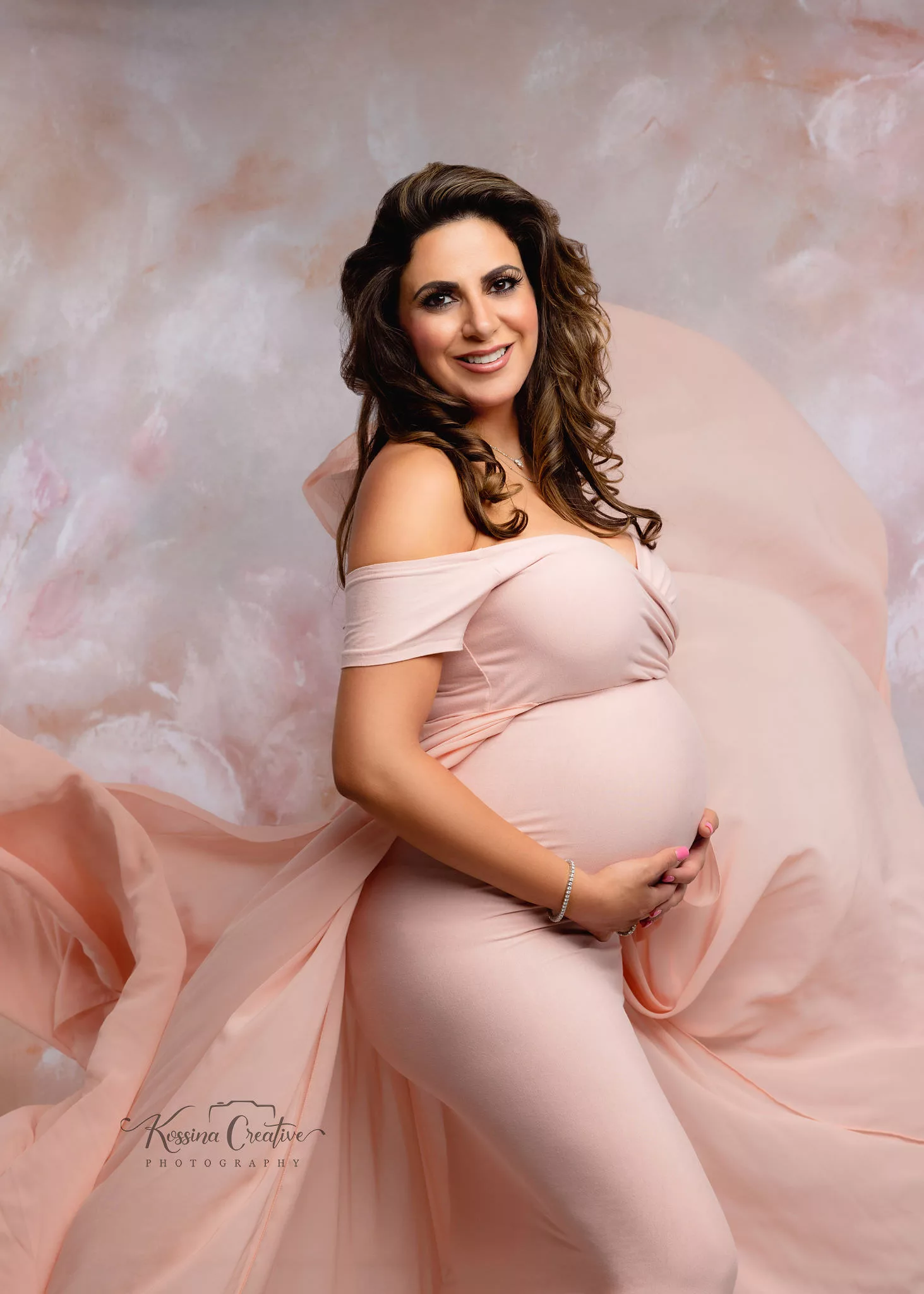 Orlando Maternity Photographer Photo Studio pink flowy dress and floral background