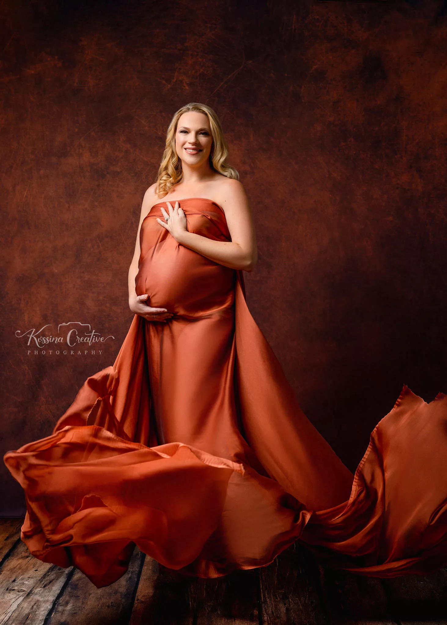 Orlando Maternity Photographer Photo Studio orange fabric with orange background