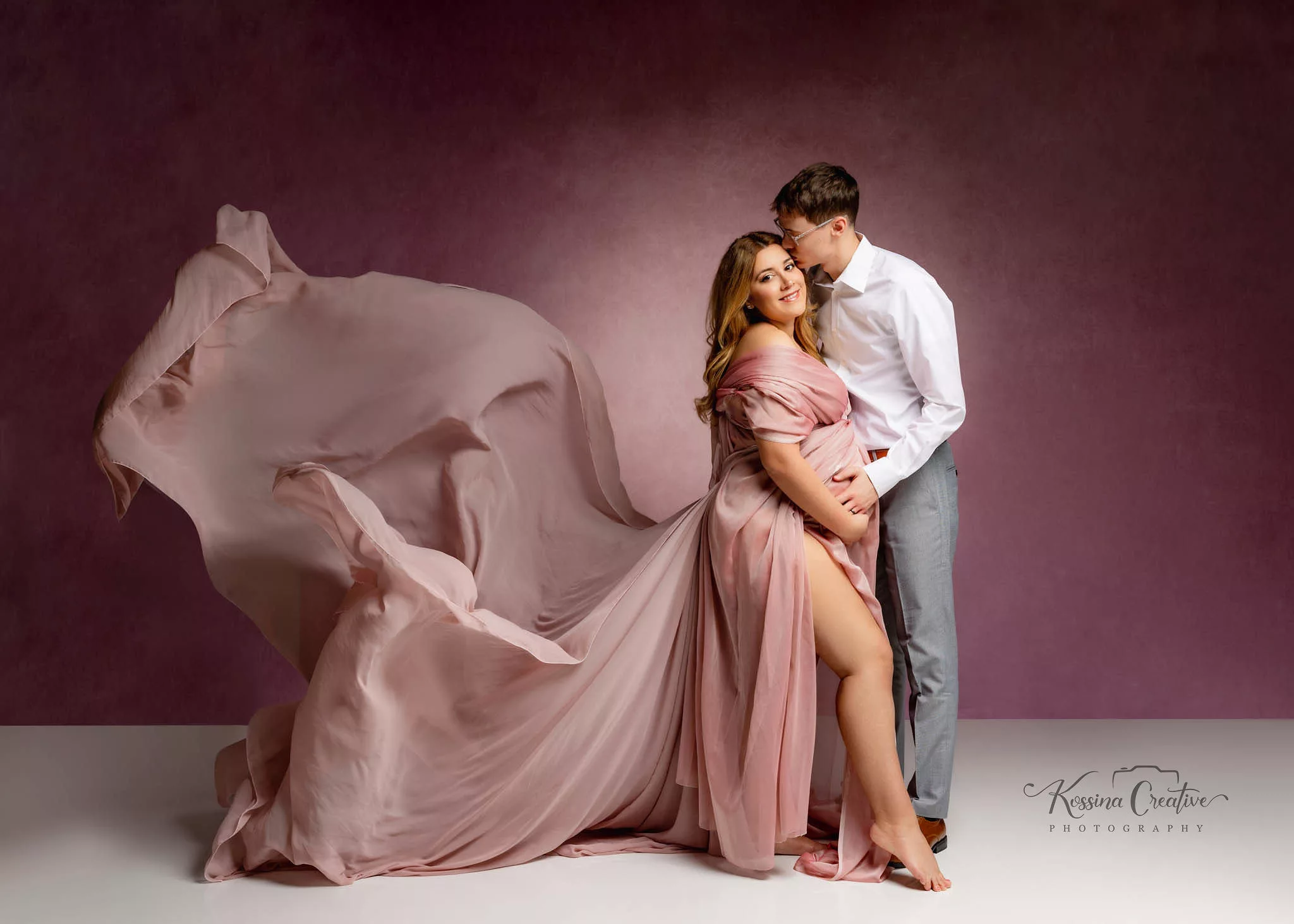 Orlando Maternity Photographer Photo Studio flowy pink dress and mauve background with husband
