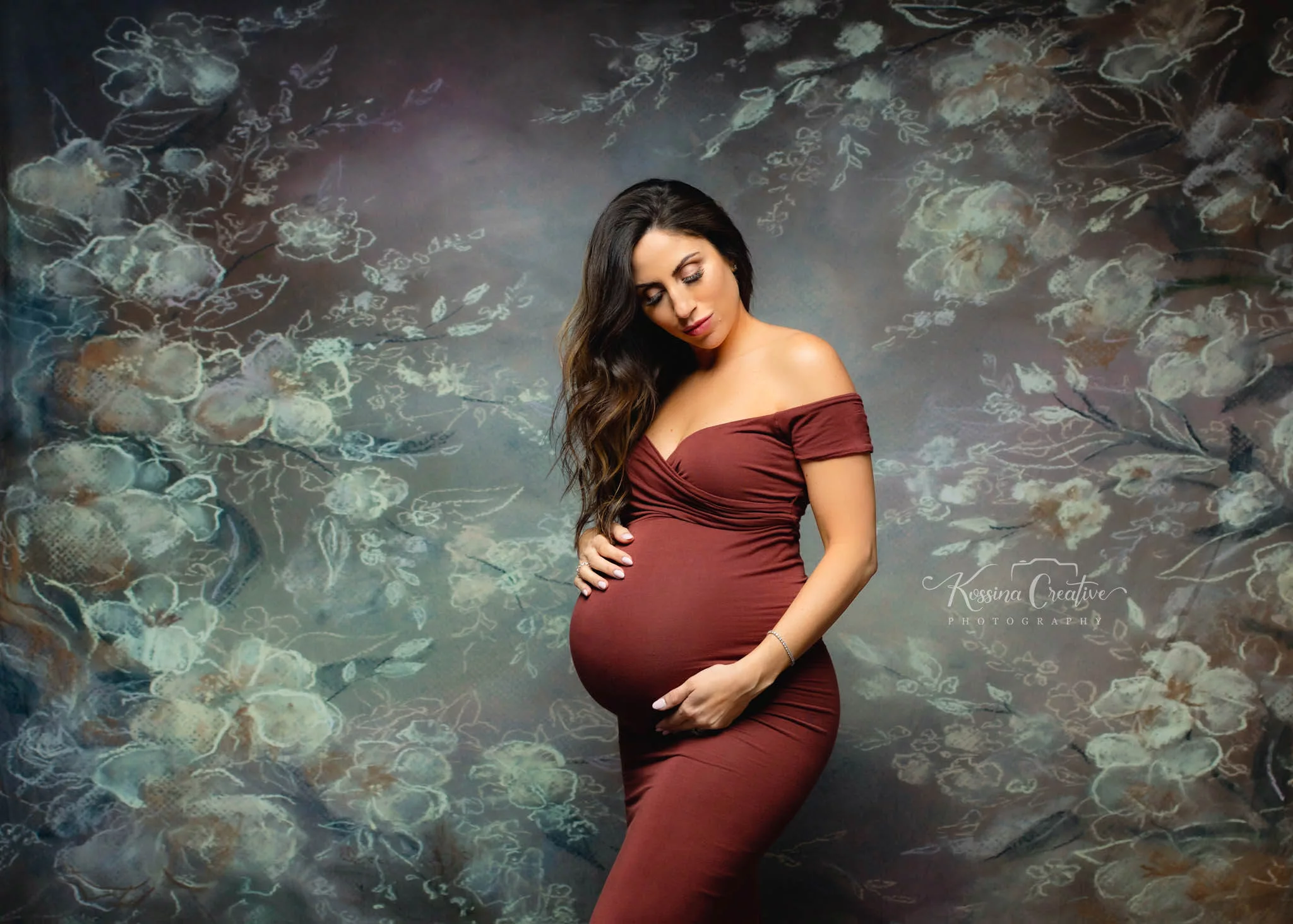 Orlando Maternity Photographer Photo Studio with white floral background and red dress