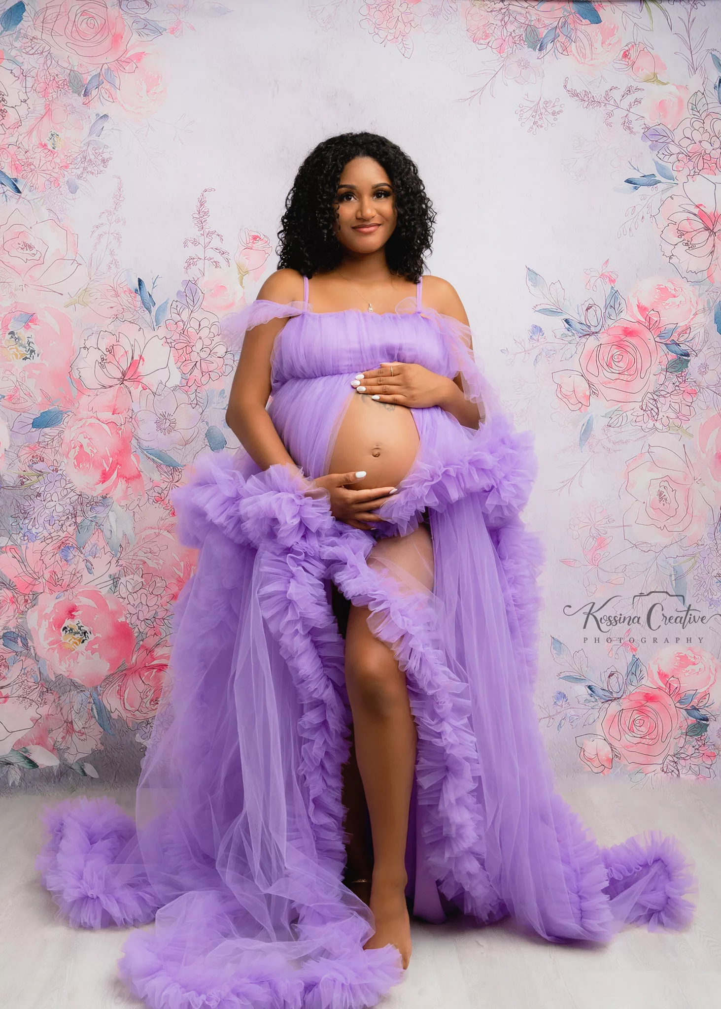 Orlando Maternity Photographer Photo Studio with purple dress and floral background