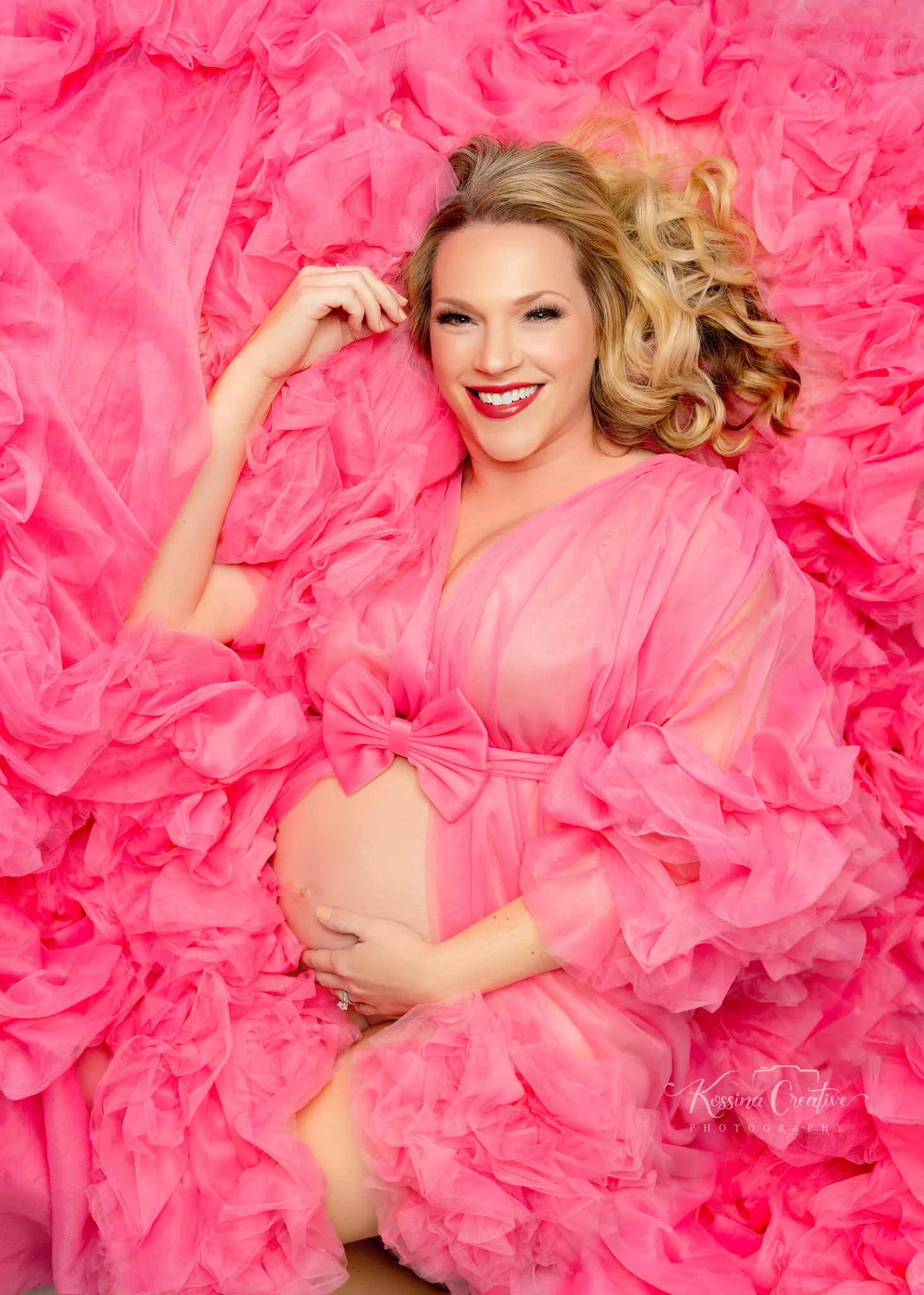 Orlando Maternity Photographer Photo Studio pink laying down fluffy dress