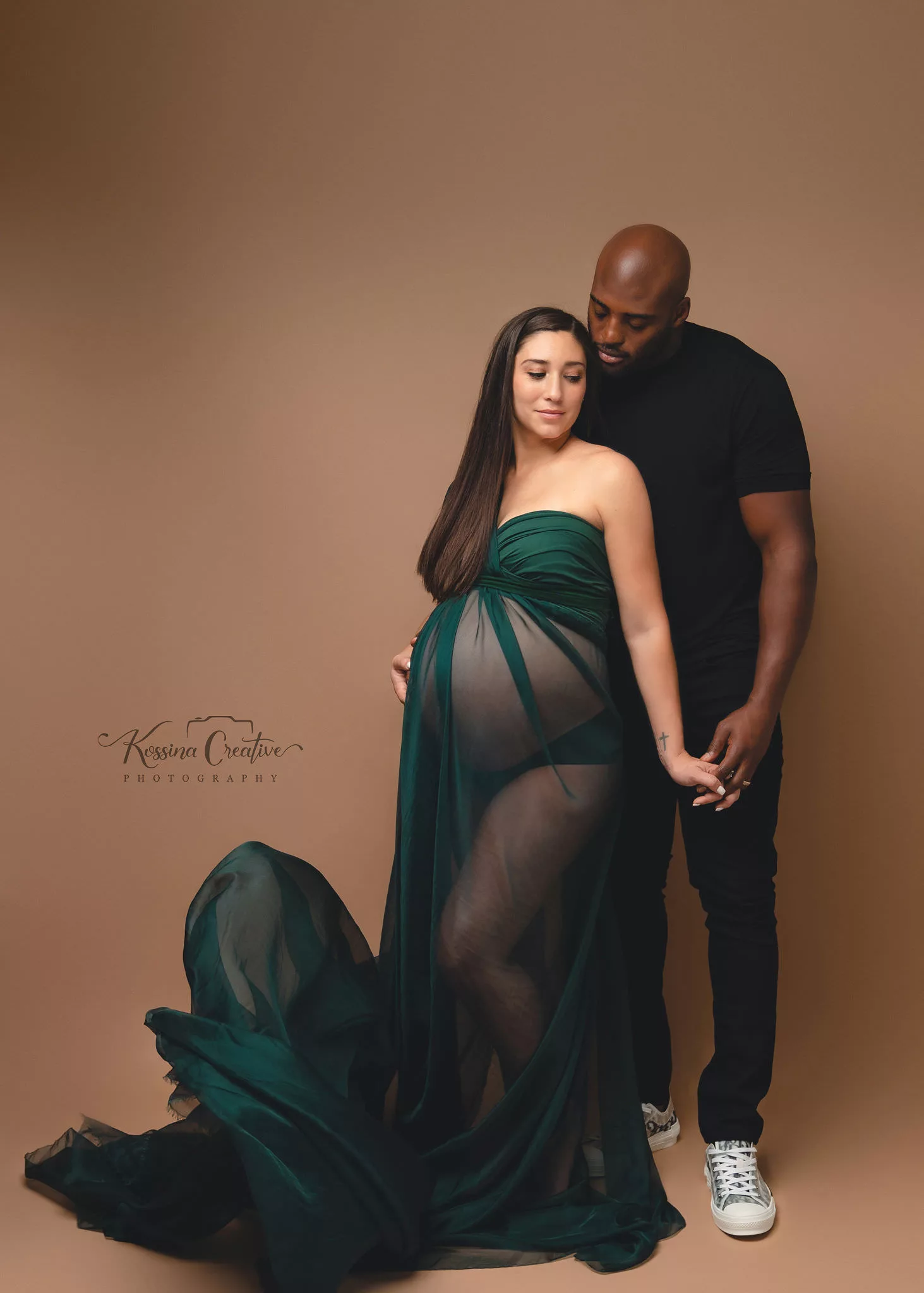 Orlando Maternity Photographer Photo Studio green flowy dress couples maternity with brown background
