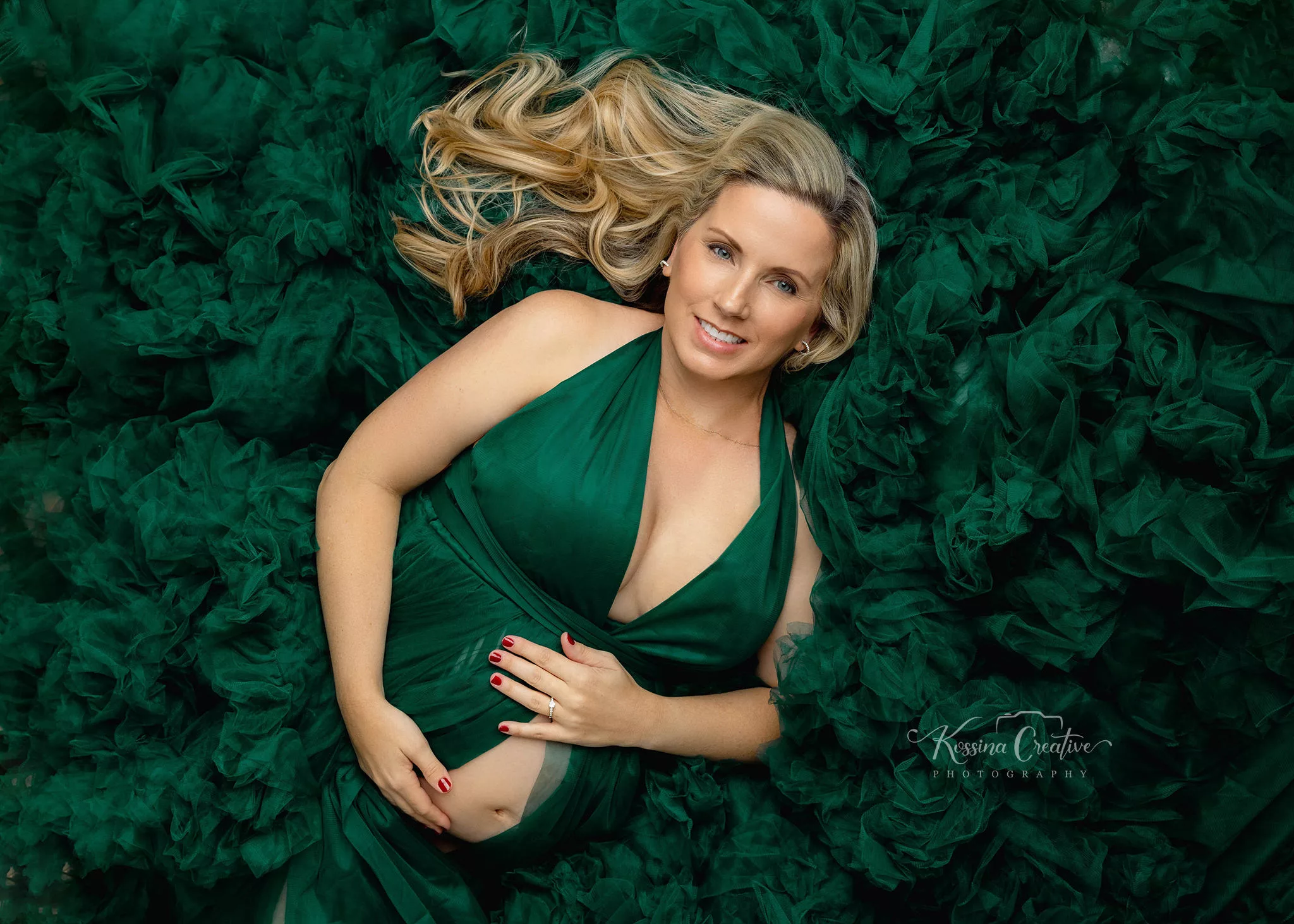 Orlando Maternity Photographer Photo Studio with green dress laying down