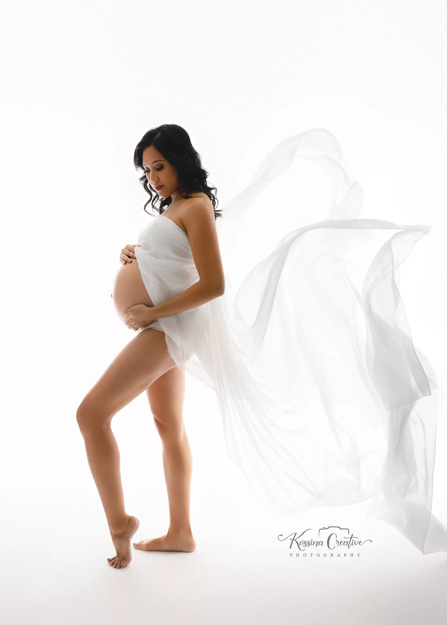 Orlando Maternity Photographer Photo Studio white flowy dress with white background