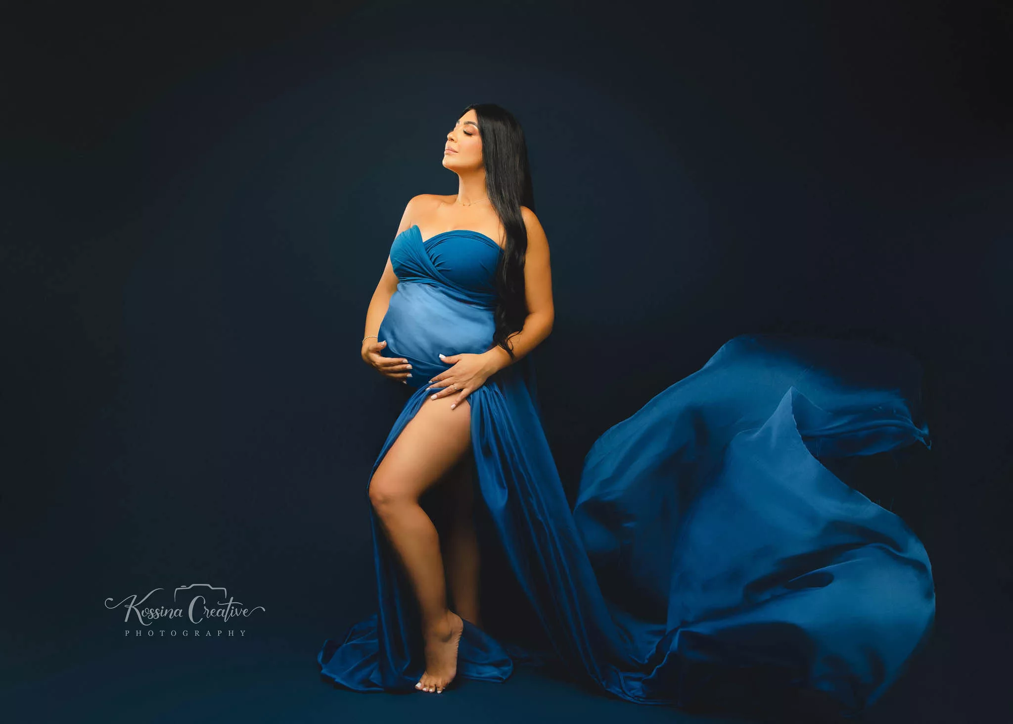 Orlando Maternity Photographer Photo Studio with blue flowy dress and blue background