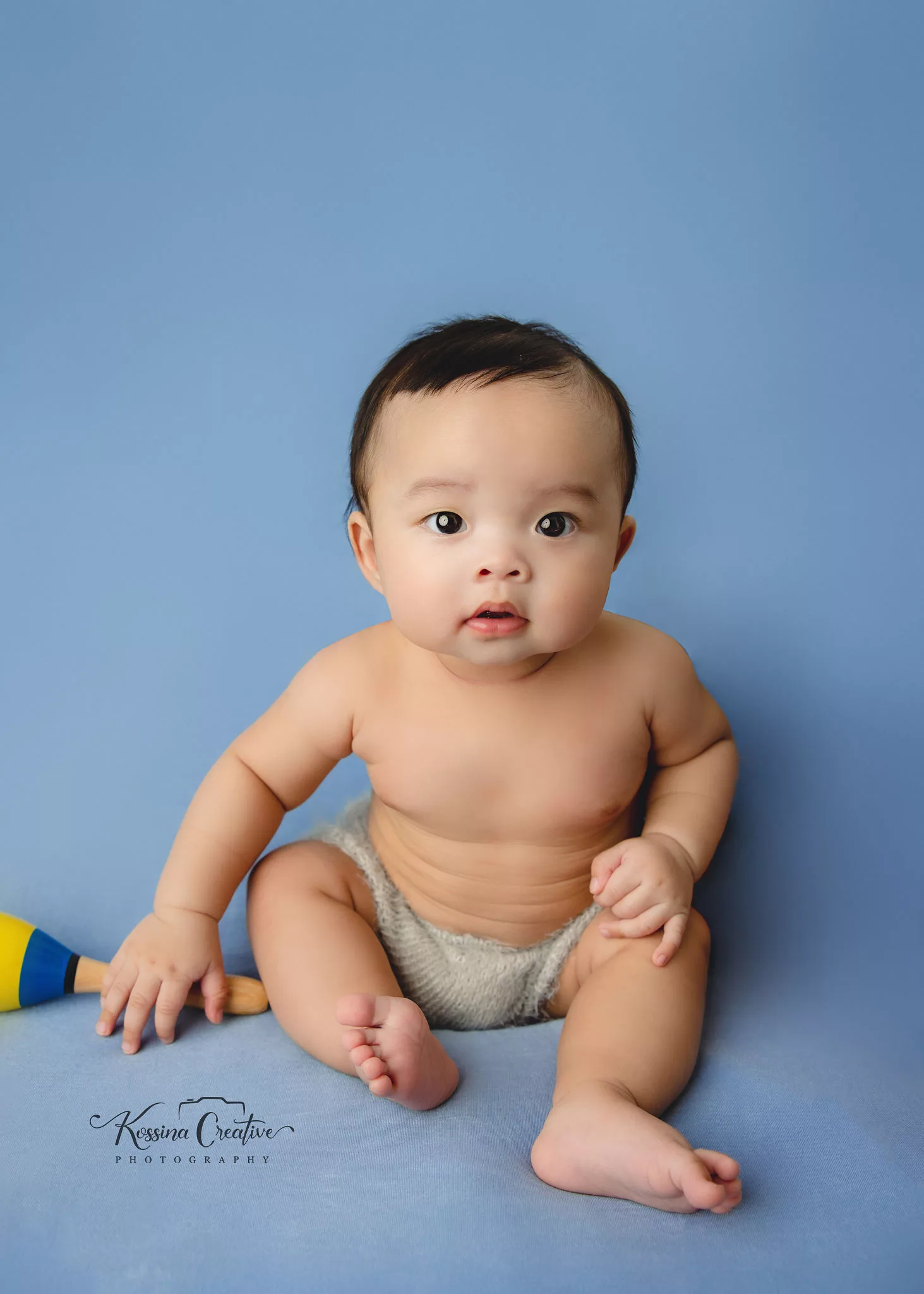 Orlando Baby Photographer 6 month sitter milestone baby boy on blue