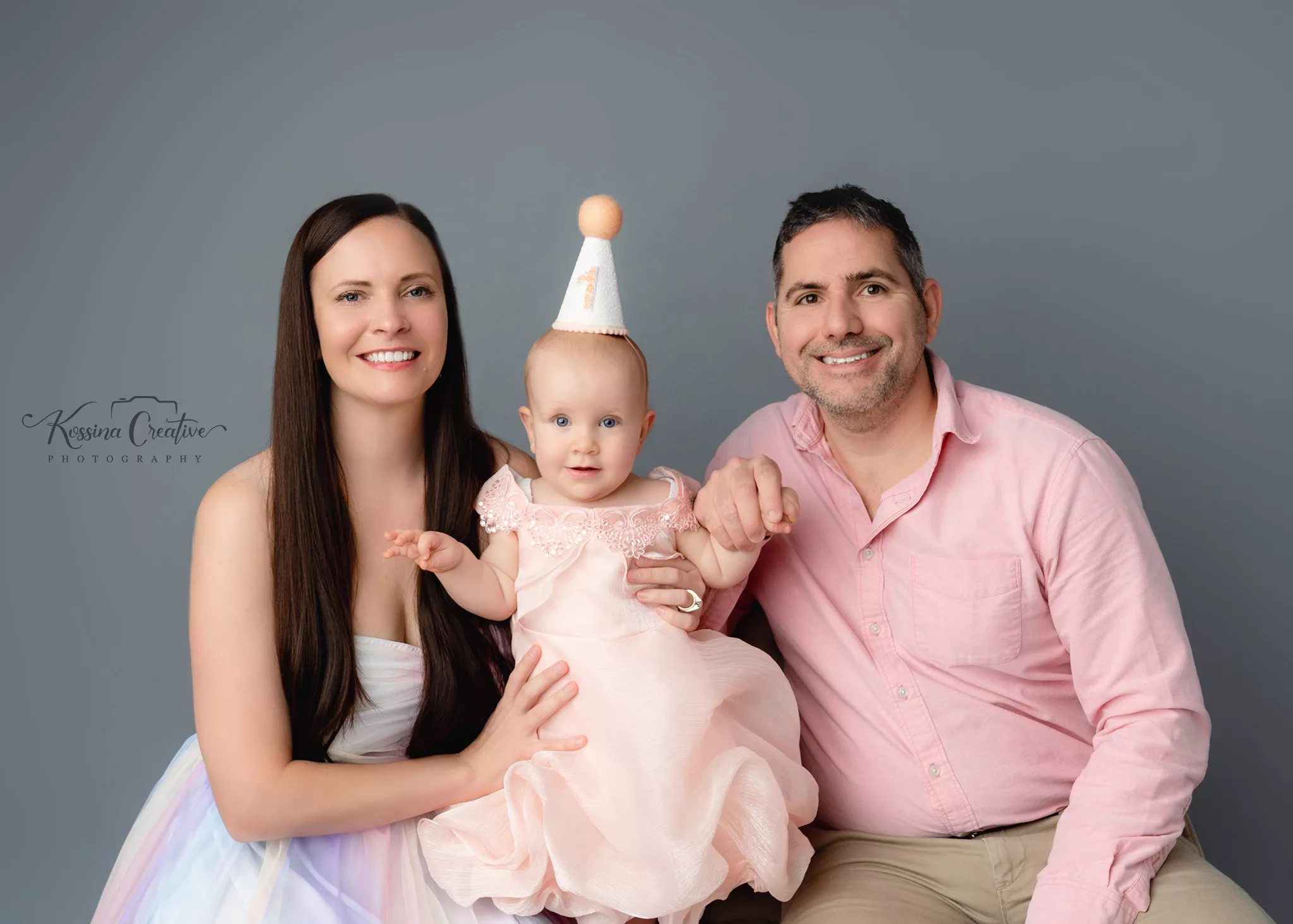 Orlando Family Cake Smash 1st Birthday Photographer Photo Studio family of three pink with birthday hat