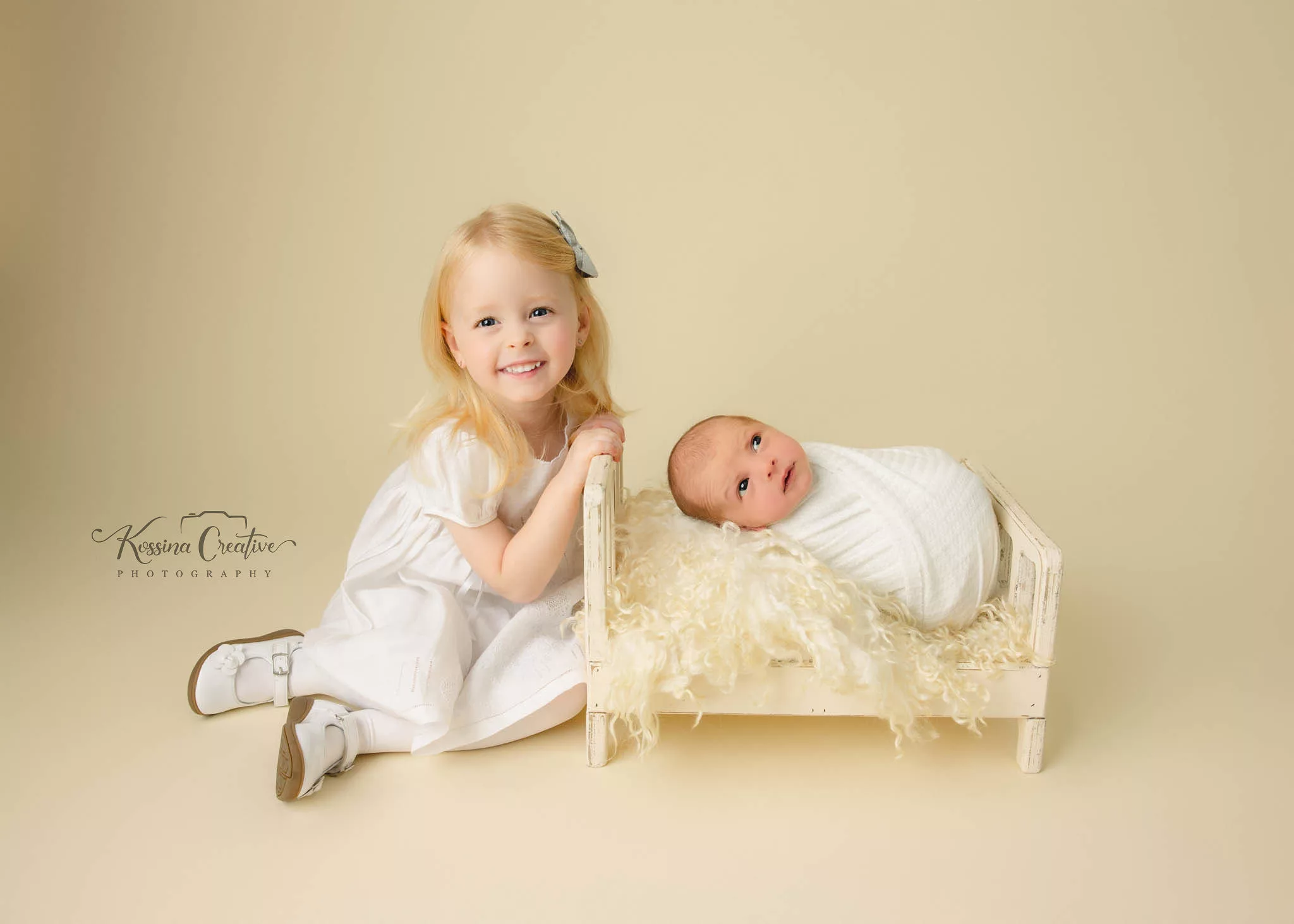 Orlando Family Newborn Photographer Baby Kid Photo studio siblings big sister little brother cream bed white clothing