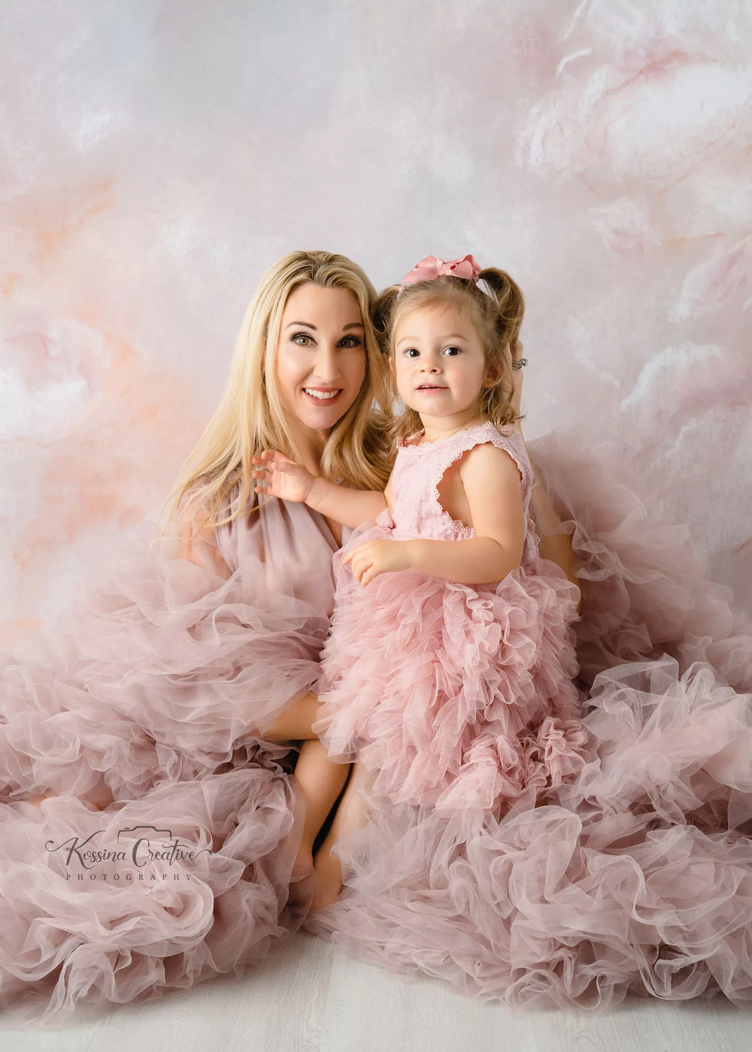 Orlando Family Photographer Motherhood Photo session mommy and me mini session mother and daughter with pink fluffy dresses and peach cloud backdrop