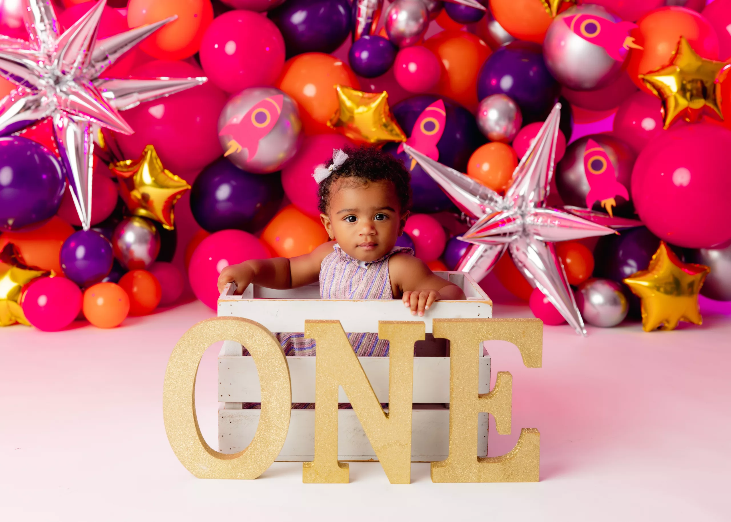 Orlando Girl Cake Smash 1st Birthday Photographer Photo Studio one letters baby in crate balloons and starts hot pink silver gold orange