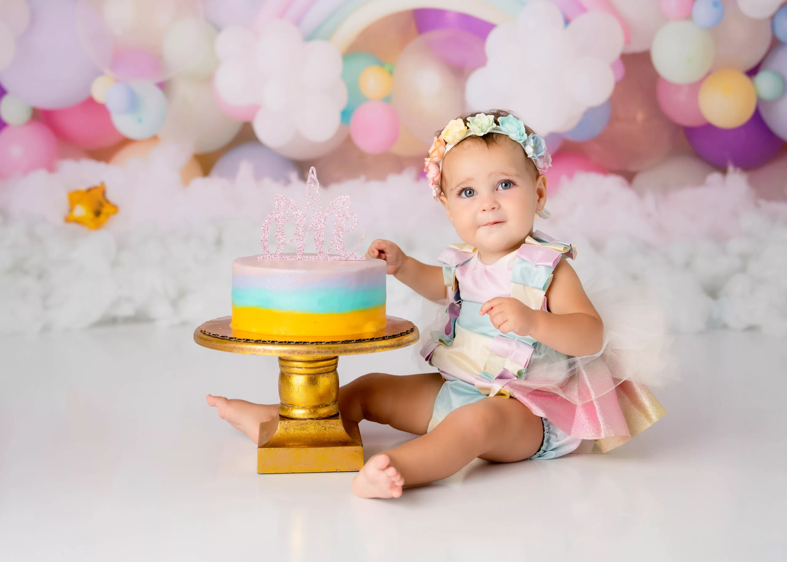 Orlando Girl Cake Smash 1st Birthday Photographer Photo Studio pastel rainbows stars clounds unicorn theme rainbow headband