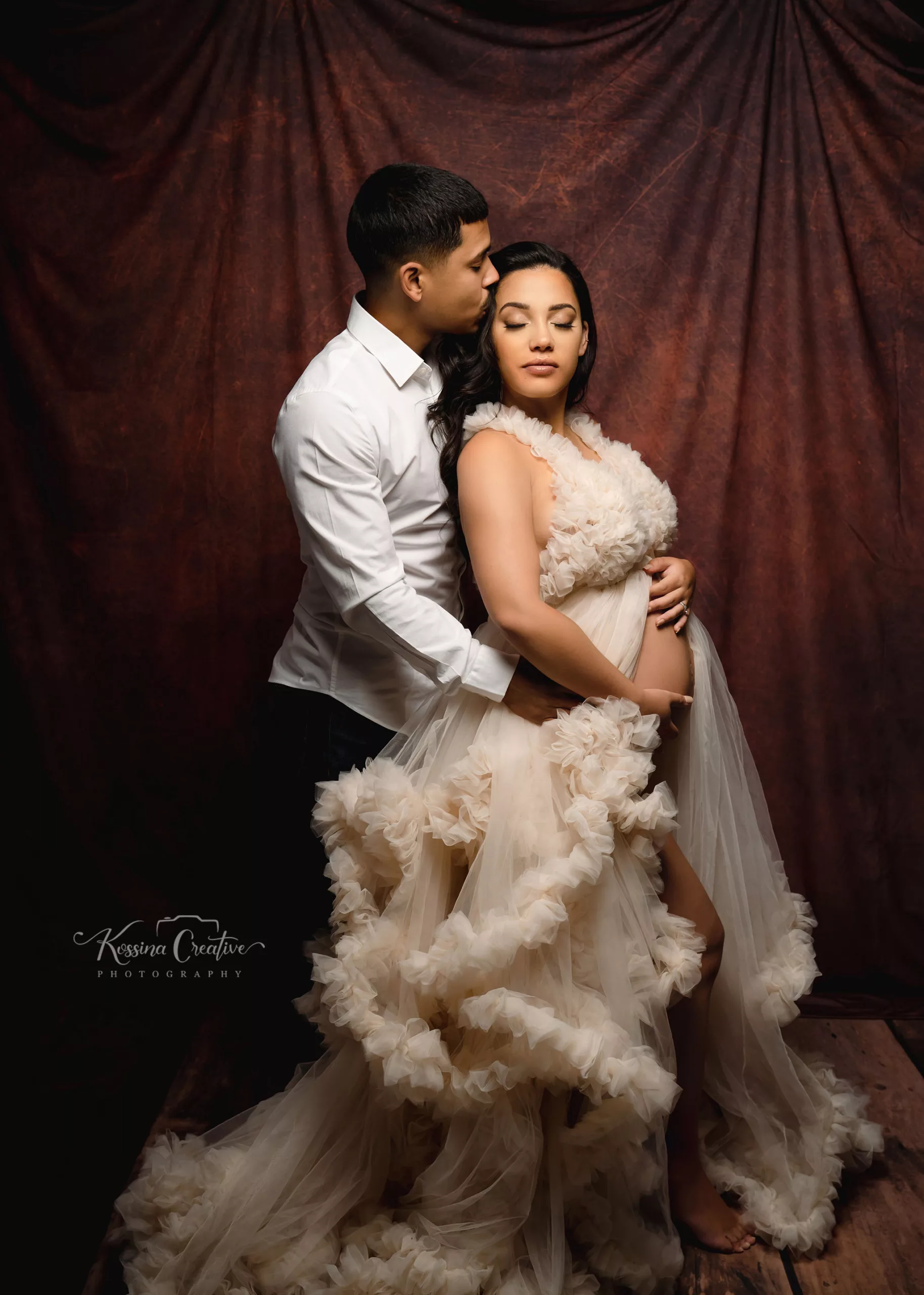 Studio Maternity in white fluffy dress and brown. background