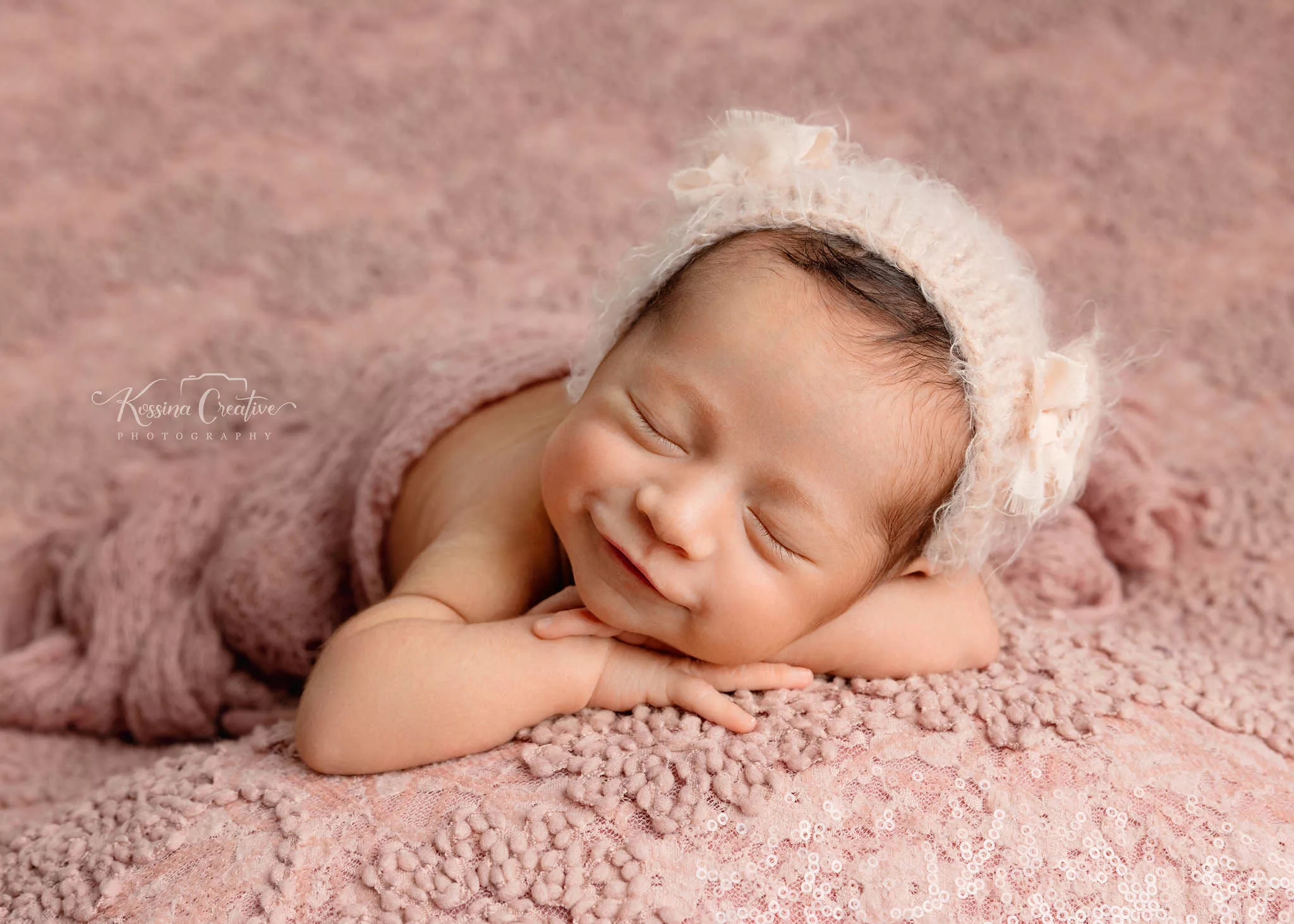Orlando Newborn Photographer Baby Girl Photo studio smiling baby bear hat with peach blanket
