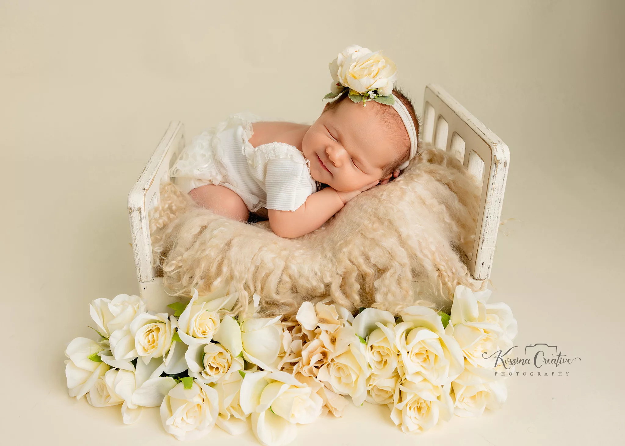 Orlando Newborn Photographer Baby Girl Photo studio cream baby bed with white roses on cream back drop