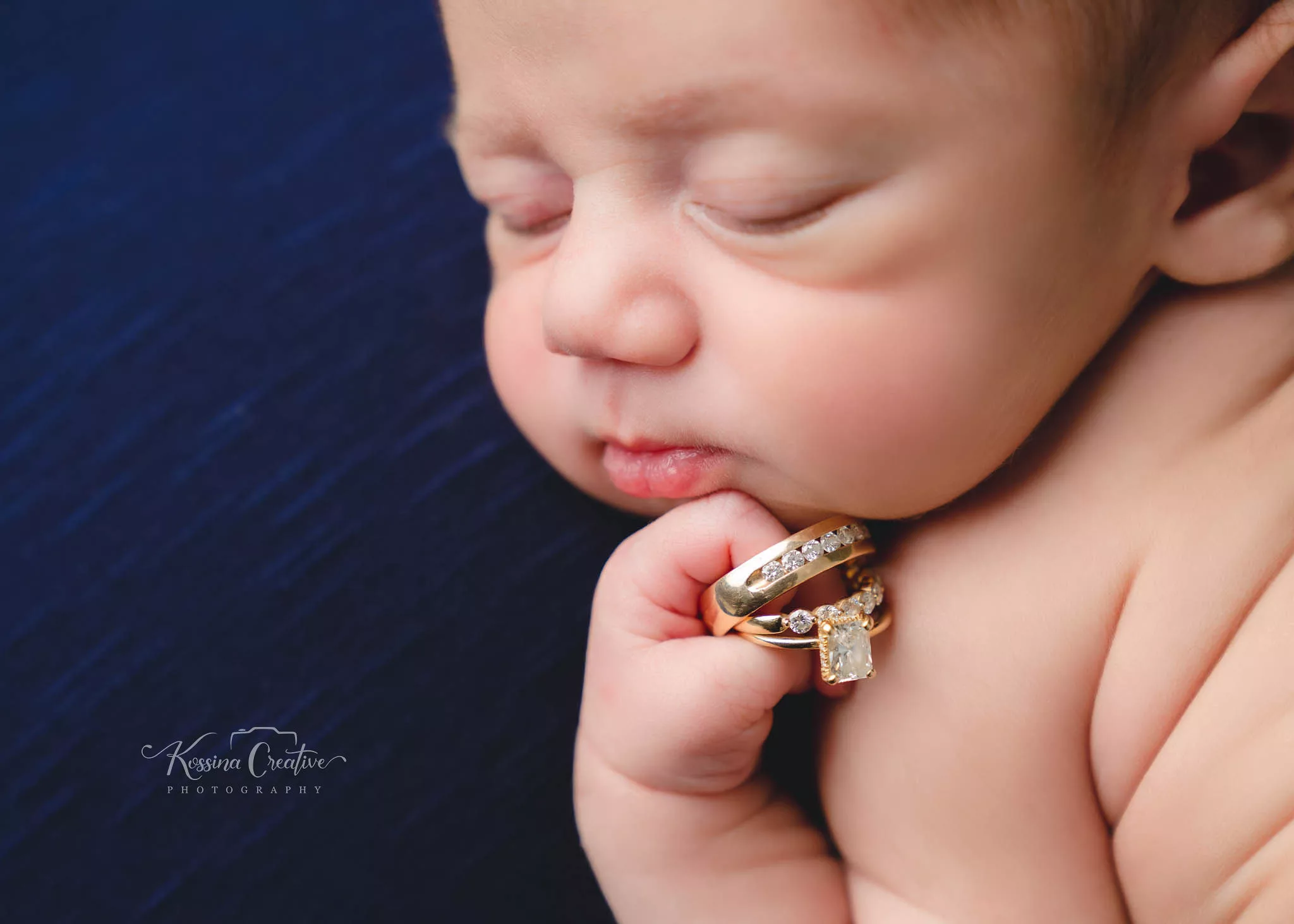 Orlando new born photography baby photo studio baby holding rings