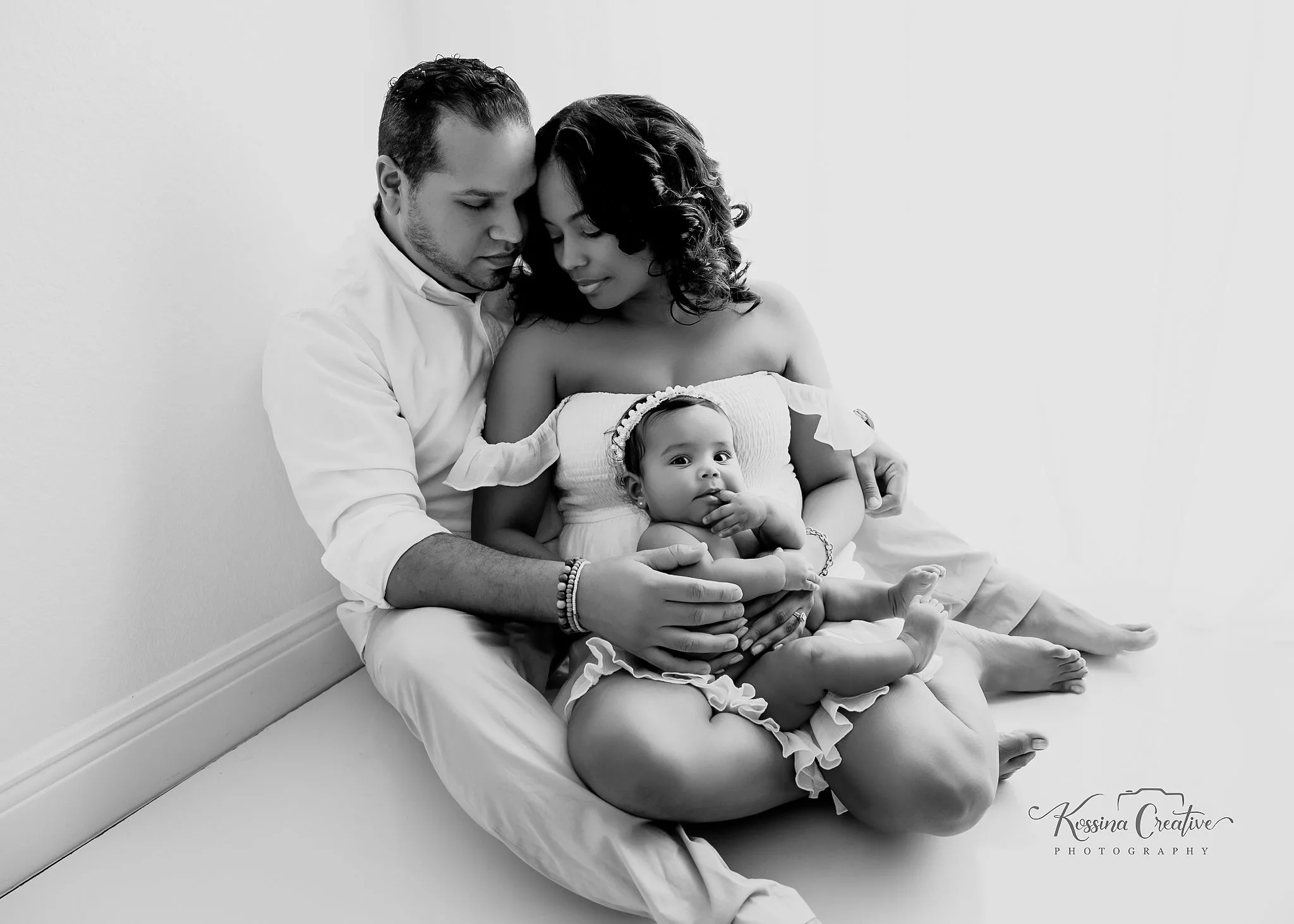 orlando photo studio family photographer studio portraits generations, black and white photo mom dad baby snuggling