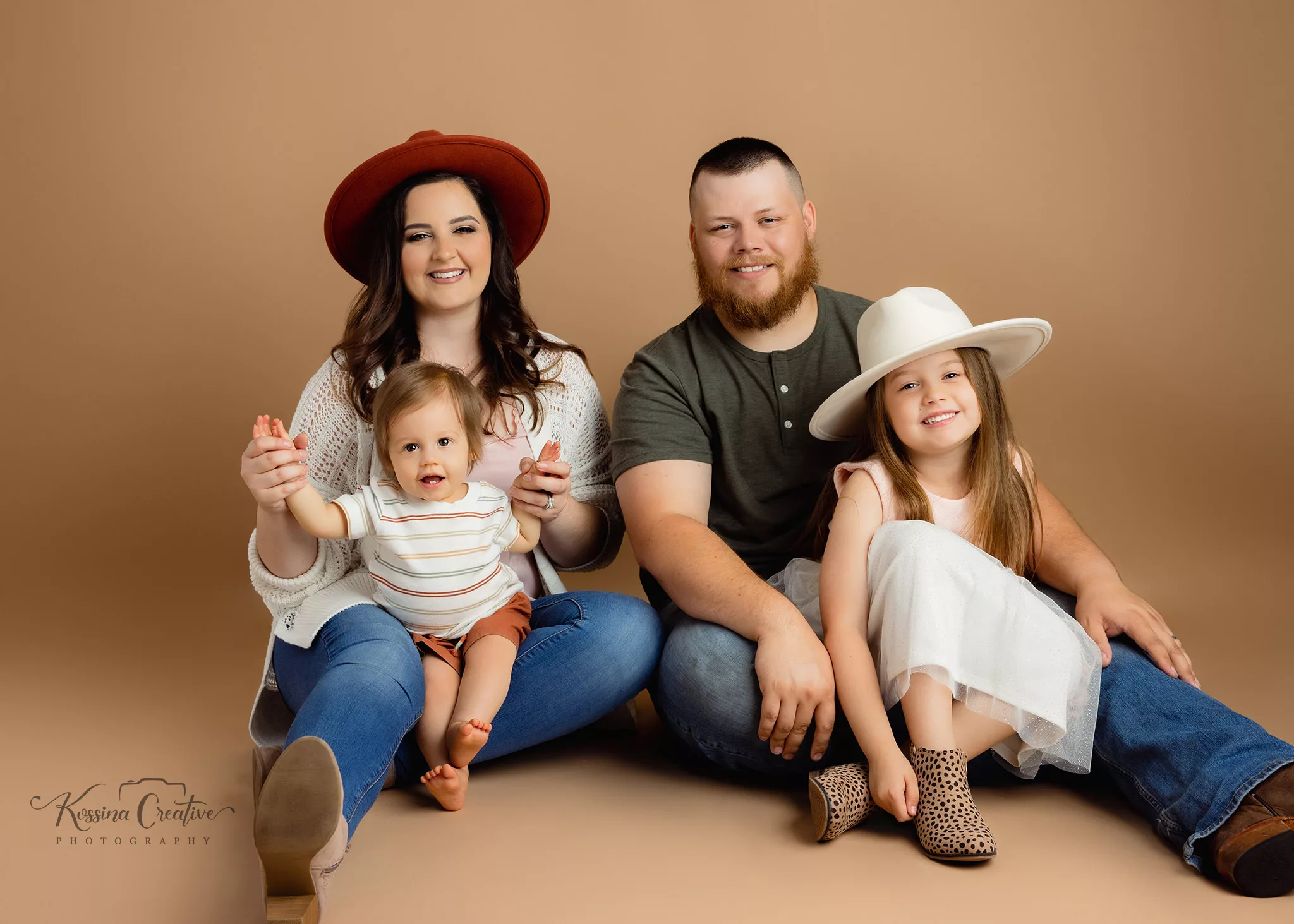 orlando photo studio family photographer studio portraits generations family of four sitting on the floor hats