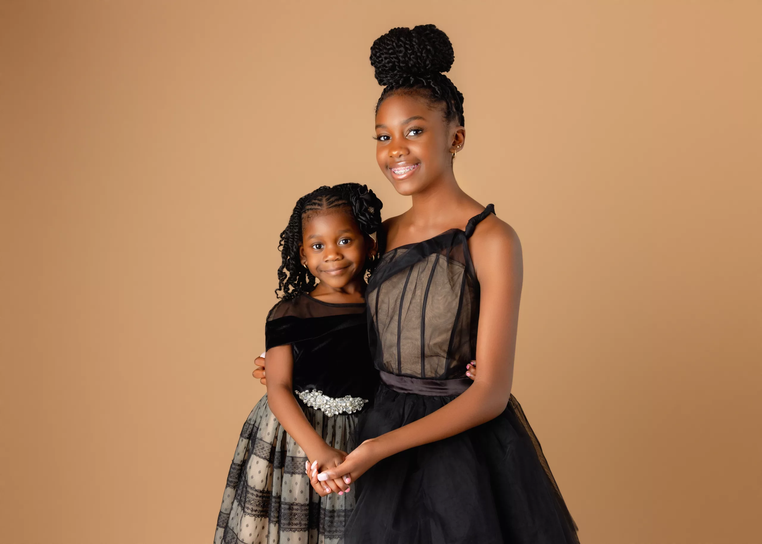 orlando photo studio family photographer studio portraits generations sisters siblings formal black dresses brown background